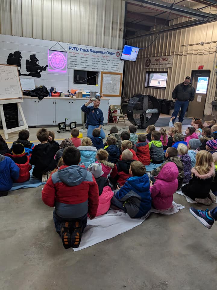 Pierce firefighters teaching children during a fire prevention visit